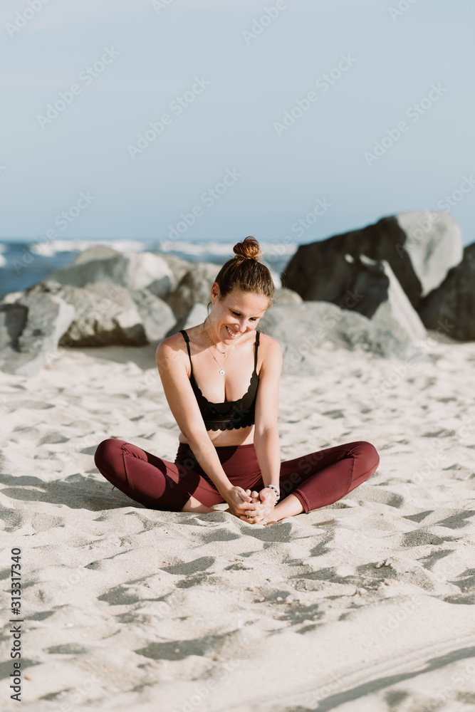 Young Woman Practicing Yoga On The Beach By The Ocean, Yoga Poses Set  Against Beautiful Background Stock Photo