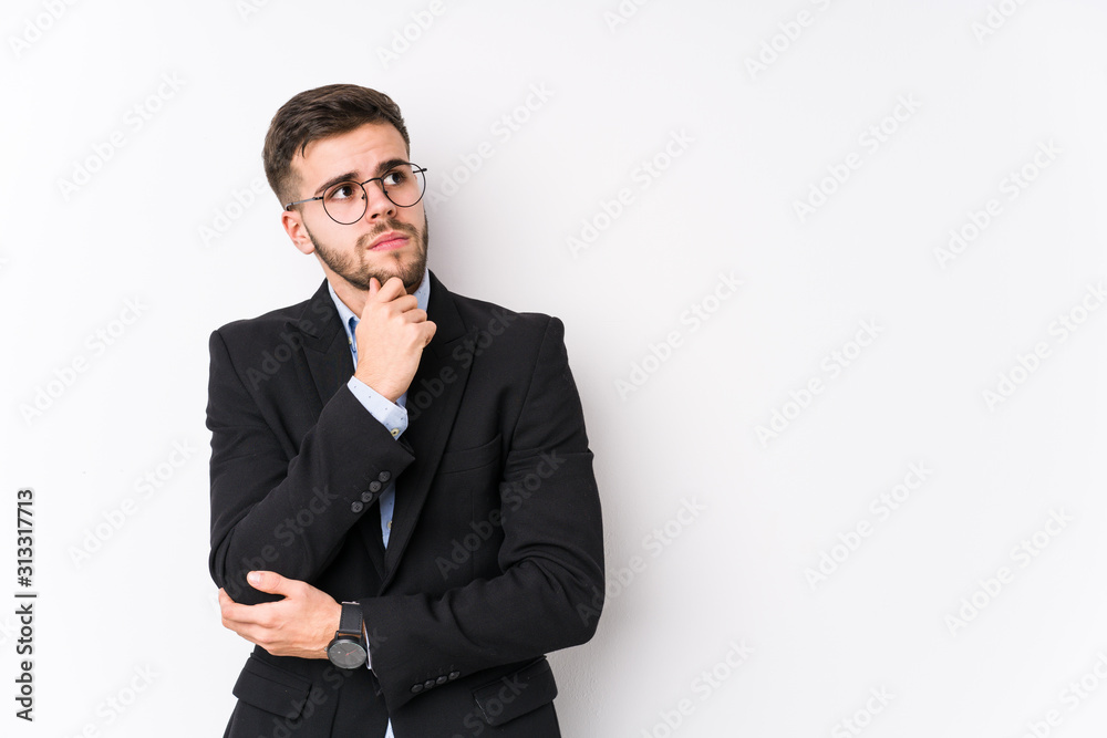 Young caucasian business man posing in a white background isolated Young caucasian business man looking sideways with doubtful and skeptical expression. Young caucasian business man posing in a white background isolated Young caucasian business man looking sideways with doubtful and skeptical expression.