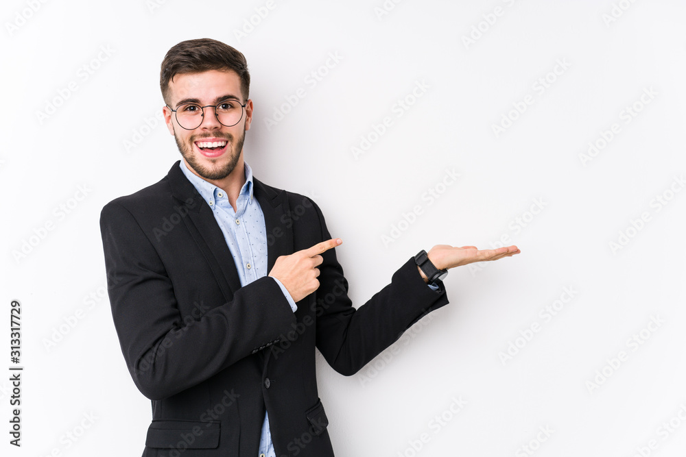 Young caucasian business man posing in a white background isolated Young caucasian business man excited holding a copy space on palm. Young caucasian business man posing in a white background isolated Young caucasian business man excited holding a copy space on palm.
