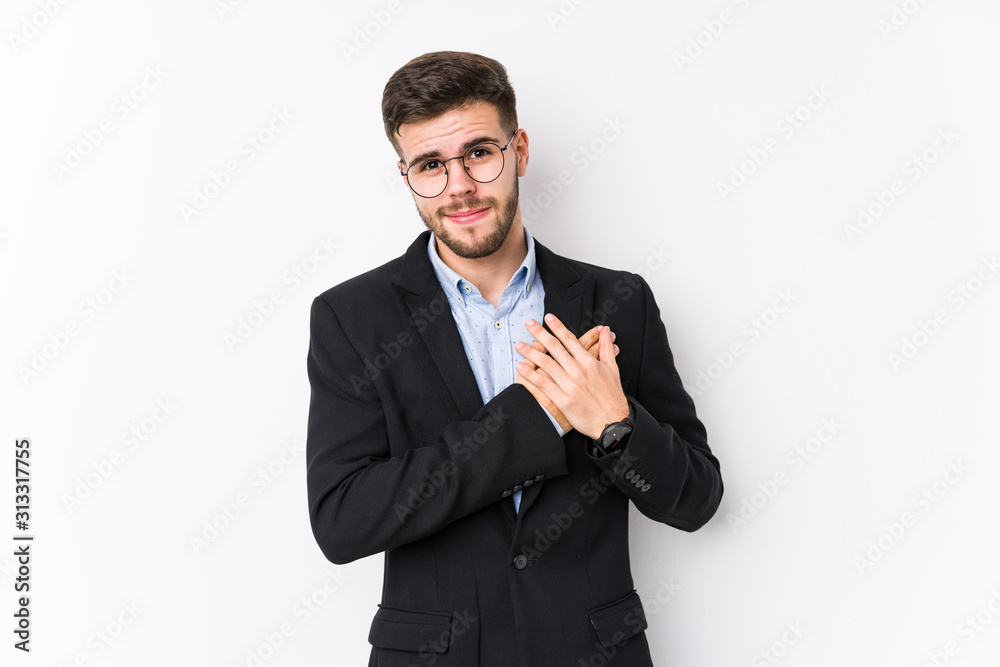 Young caucasian business man posing in a white background isolated Young caucasian business man has friendly expression, pressing palm to chest. Love concept. Young caucasian business man posing in a white background isolated Young caucasian business man has friendly expression, pressing palm to chest. Love concept.