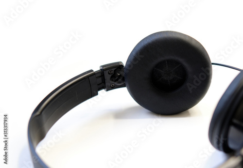 Classic black wired headphones on white background. Minimalistic music concept