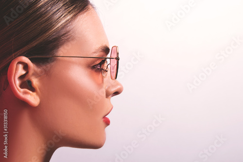 Portrait of beautiful model with close up glasses. Young woman, brunette girl with sunglasses, isolated, commercial poster ready, studio 