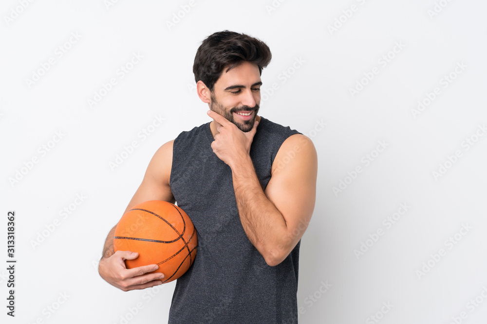 Basketball player man with beard over isolated white background looking side Basketball player man with beard over isolated white background looking side