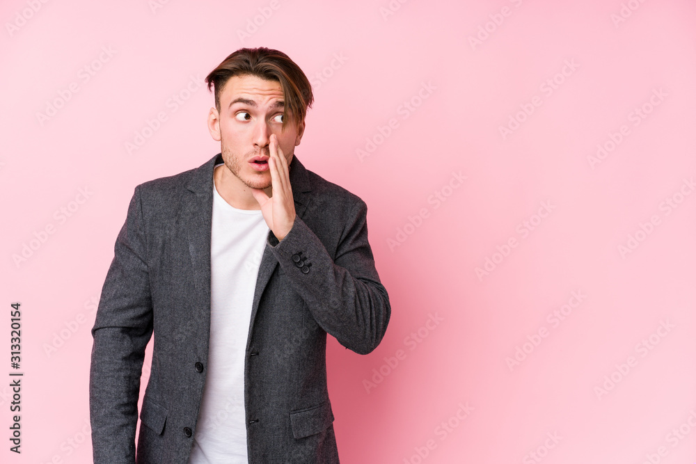 Young caucasian business man posing isolated is saying a secret hot braking news and looking aside Young caucasian business man posing isolated is saying a secret hot braking news and looking aside