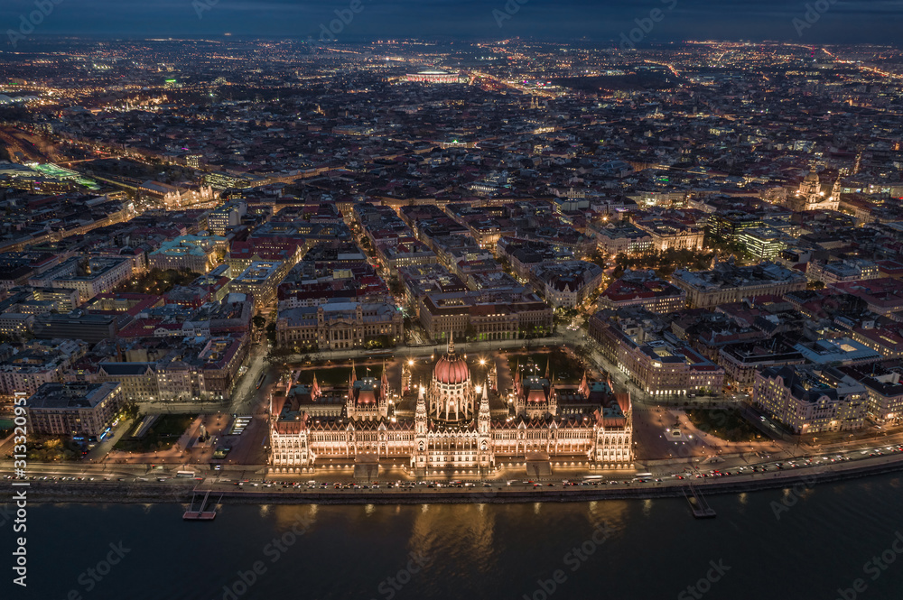 Budapest, Hungary - Aerial skyline view of Budapest by night. This view includes the illuminated Hungarian Parliament building, St. Stephen's Basilica, Nyugati Railway Station and the new Puskas Arena