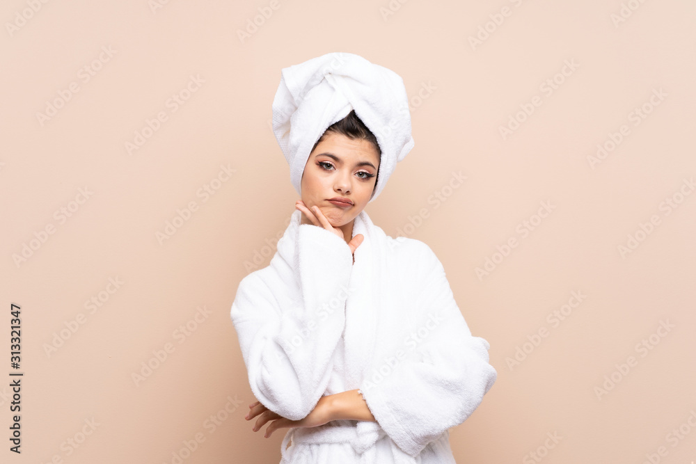 Teenager girl in a bathrobe over isolated background unhappy and frustrated Teenager girl in a bathrobe over isolated background unhappy and frustrated