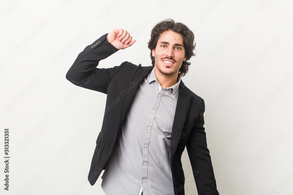 Young business man against a white background stretching arms, relaxed position. Young business man against a white background stretching arms, relaxed position.