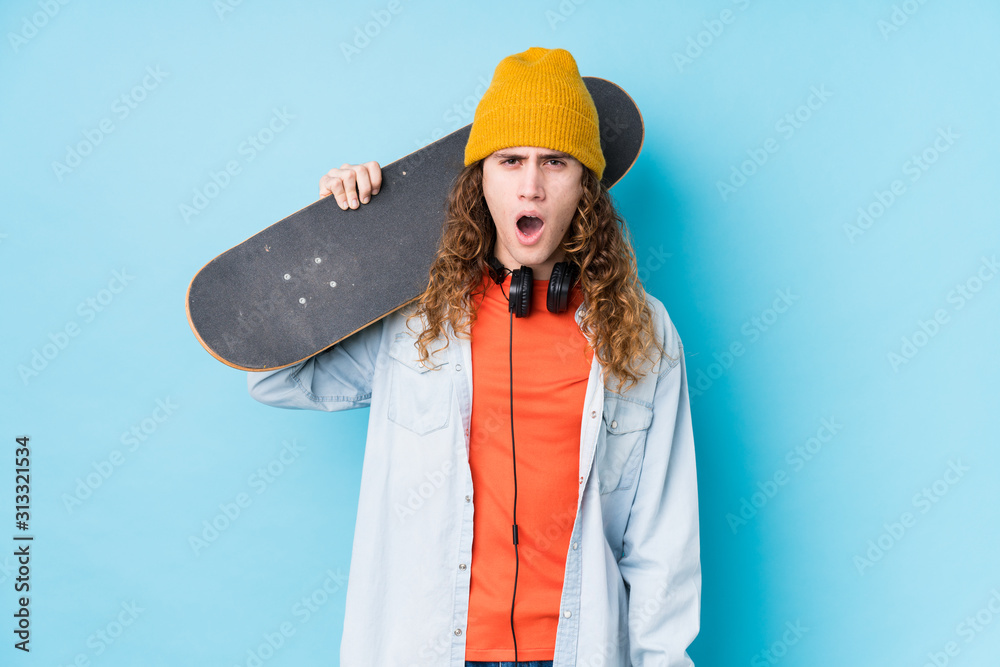 Young caucasian skater man isolated screaming very angry and aggressive.