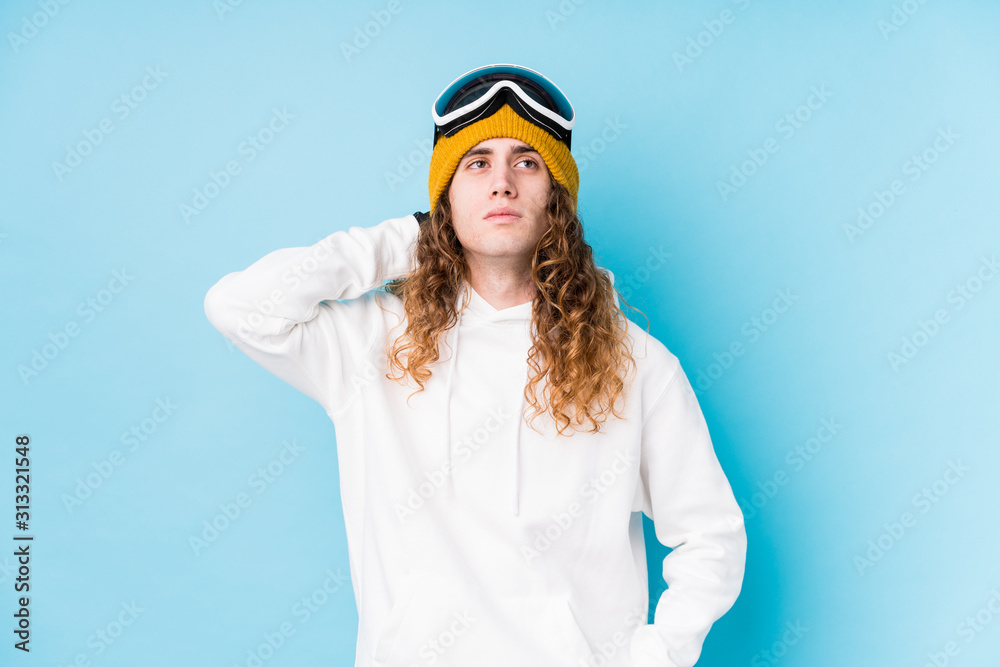 Young caucasian man wearing a ski clothes isolated touching back of head, thinking and making a choice. Young caucasian man wearing a ski clothes isolated touching back of head, thinking and making a choice.