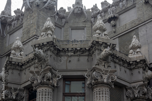 Capital and the upper part of the facade with sculptures of animals on the historic Art Nouveau building, called 