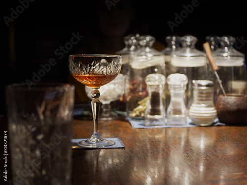 Glass with cocktail on desk