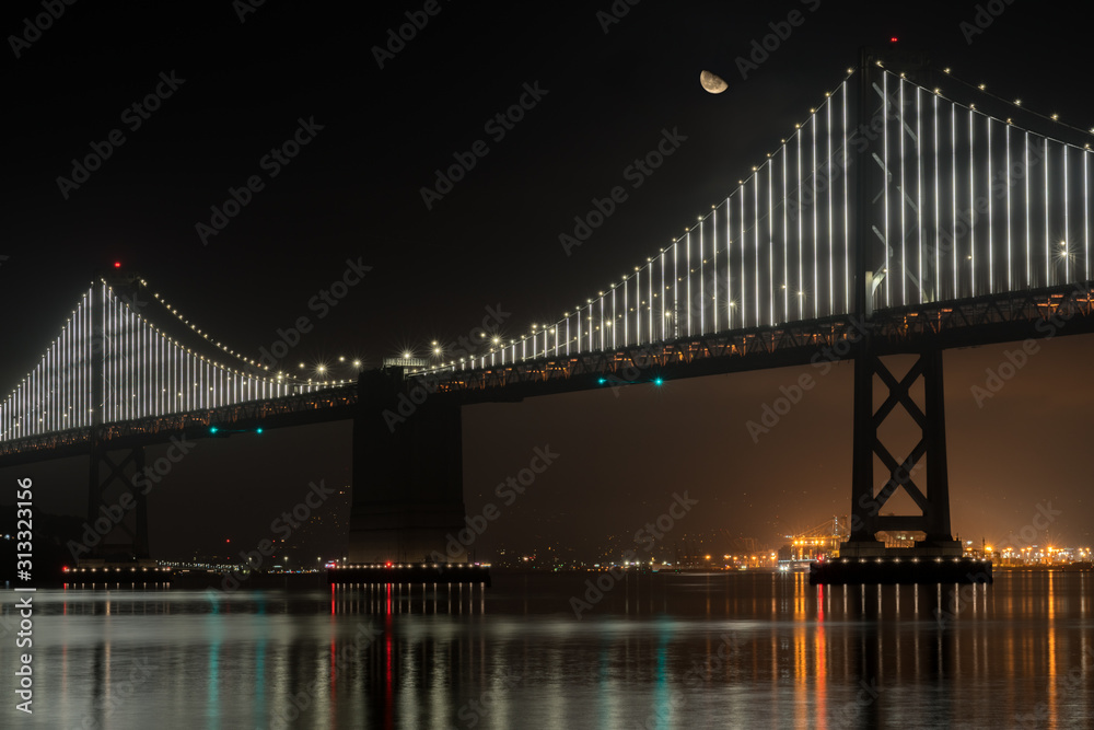 View of Half Moon Over the San Francisco Oakland Bridge at Night