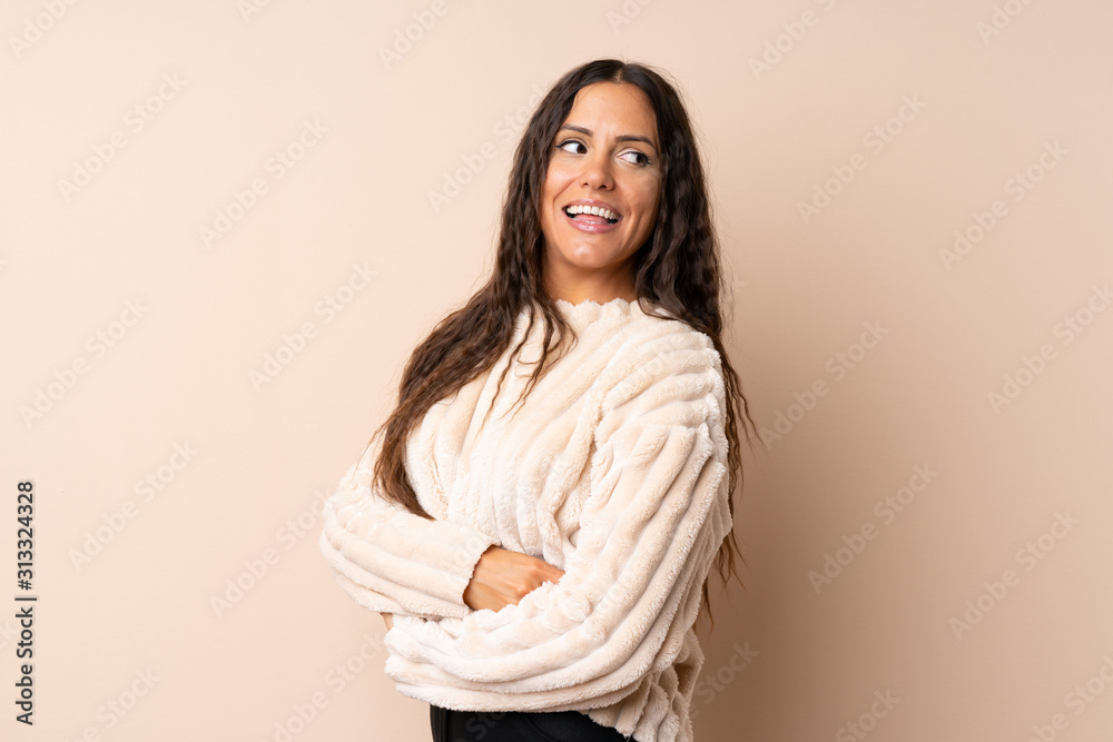 Young woman over isolated background with arms crossed and happy Young woman over isolated background with arms crossed and happy