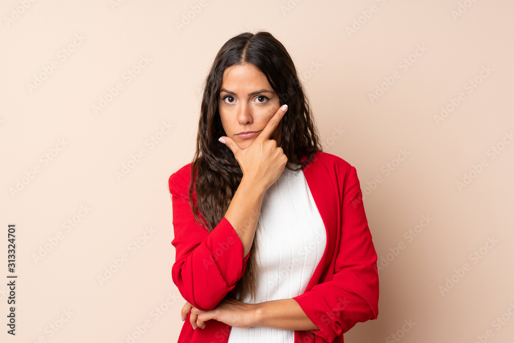 Young woman over isolated background thinking an idea Young woman over isolated background thinking an idea