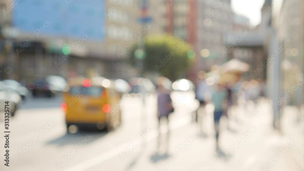 Abstract blurry New York City scenery with street traffic and unrecognizable people walking, sunny bright summer day Abstract blurry New York City scenery with street traffic and unrecognizable people walking, sunny bright summer day