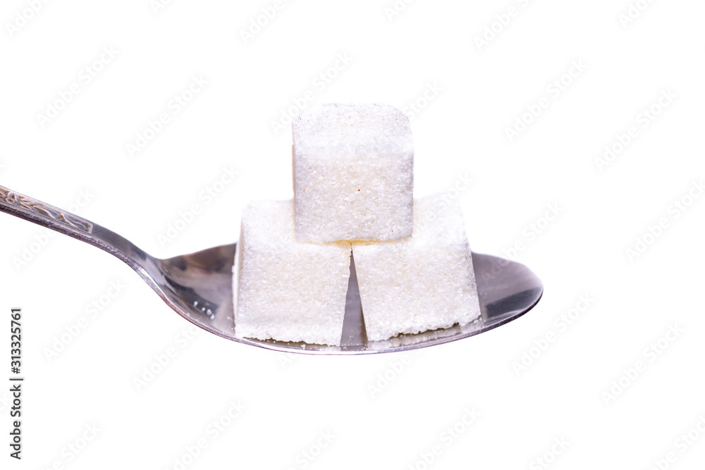 A teaspoon with three pieces of sugar on a white background. close up.