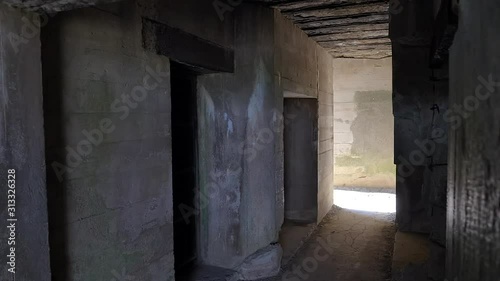 Interior of German bunker ruins in Atlantic wall, Longues sur Mer, Normandy, France. Slow reveal photo