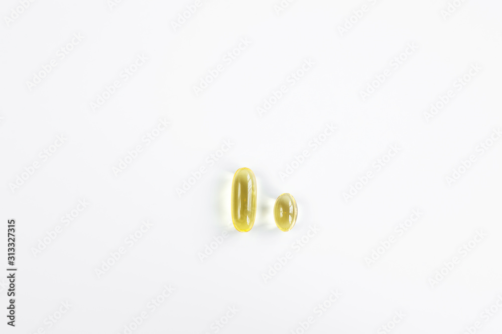 2 Capsules with fish oil, large and small Omega-3 for the cardiovascular system of the body. Top view 2 Capsules with fish oil, large and small Omega-3 for the cardiovascular system of the body. Top view