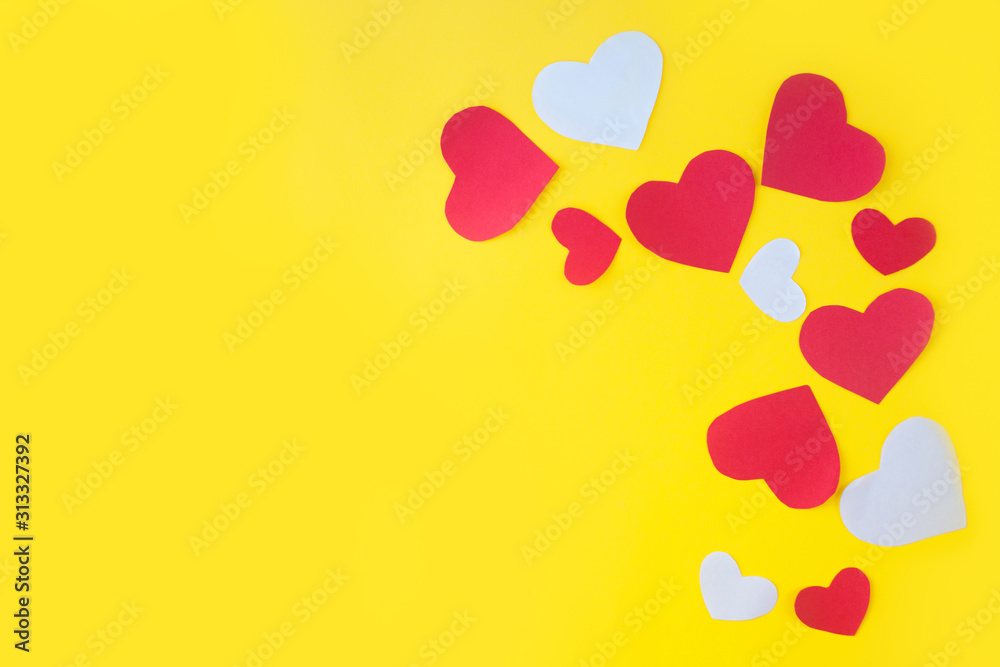Valentine's Day background. Red hearts on yellow background. Valentines day concept. Flat lay, top view, copy space Valentine's Day background. Red hearts on yellow background. Valentines day concept. Flat lay, top view, copy space