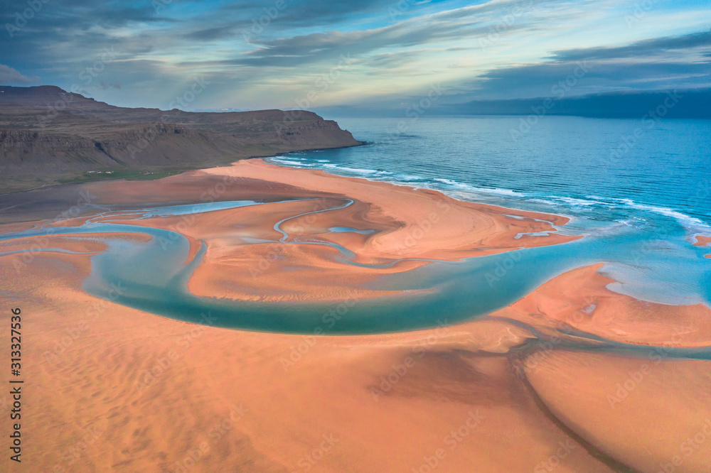 Aerial drone view of icelandic Raudasandur beach with azure water streams and yellow sand