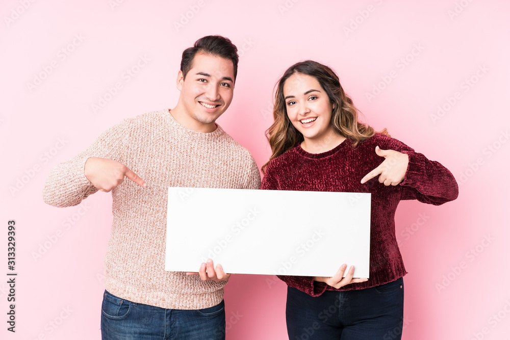 Young latin couple holding a placard Young latin couple holding a placard