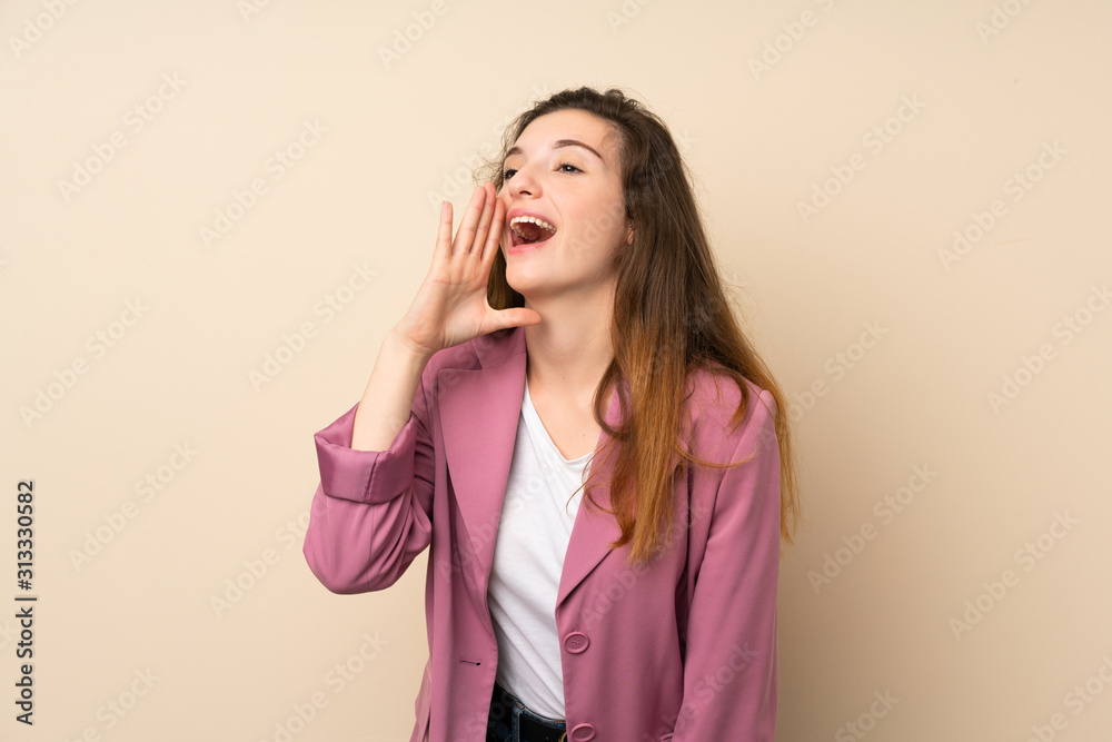 Young brunette girl with blazer over isolated background shouting with mouth wide open to the lateral Young brunette girl with blazer over isolated background shouting with mouth wide open to the lateral
