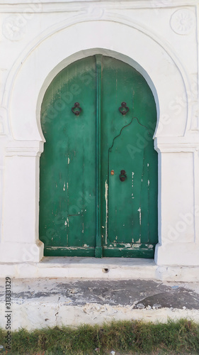 Traditional old painted door in a historical district or medina  Tunisia. Colorful textured image of muslim architecture.