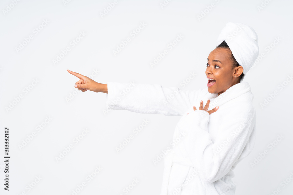 African american woman in a bathrobe over isolated background pointing finger to the side African american woman in a bathrobe over isolated background pointing finger to the side