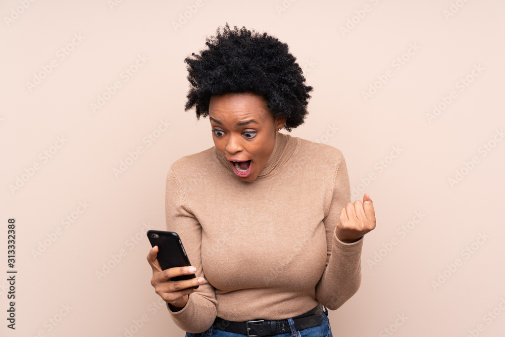 African american woman over isolated background surprised and sending a message African american woman over isolated background surprised and sending a message