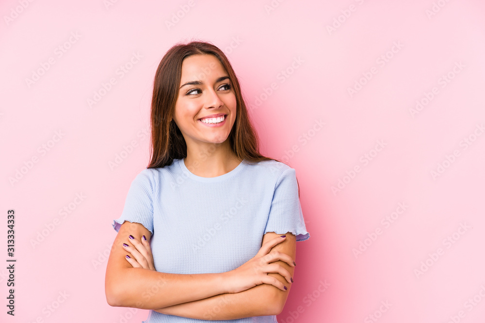 Fototapeta premium Young caucasian woman wearing a ski clothes isolated smiling confident with crossed arms.