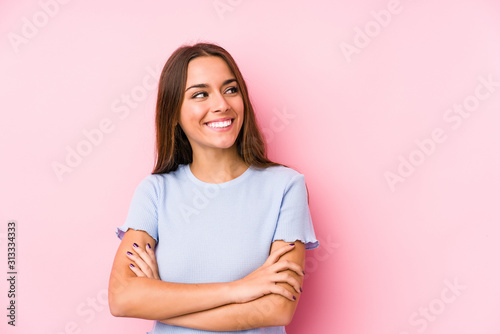 Young caucasian woman wearing a ski clothes isolated smiling confident with crossed arms. © Asier