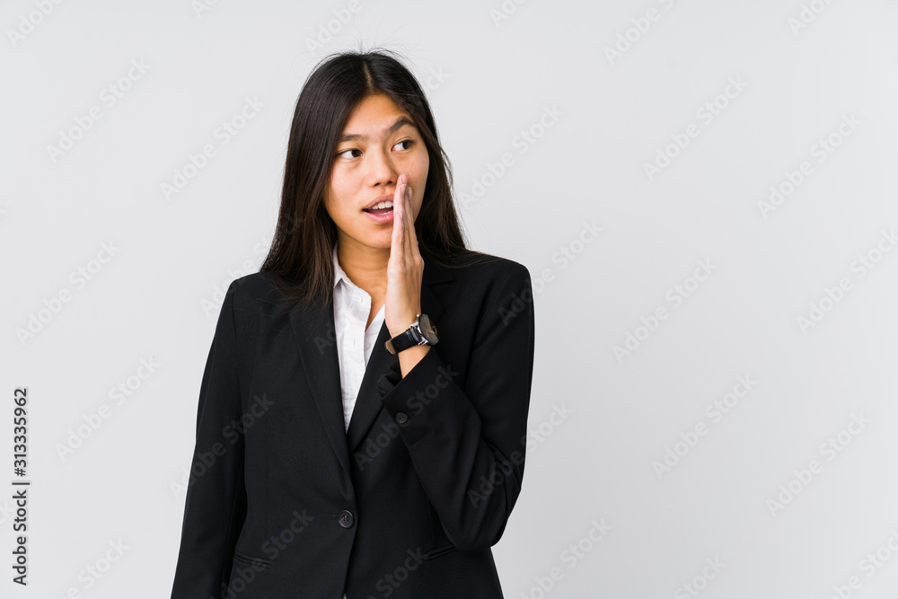 Young asian business woman is saying a secret hot braking news and looking aside Young asian business woman is saying a secret hot braking news and looking aside