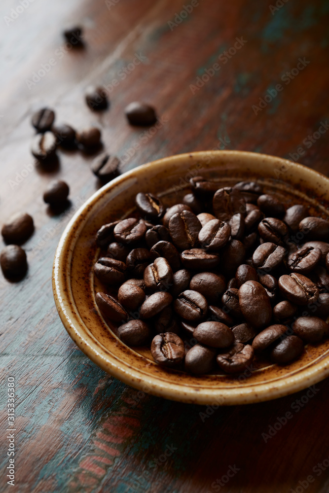 Fototapeta premium Coffee beans on rustic wooden background. Close up. 
