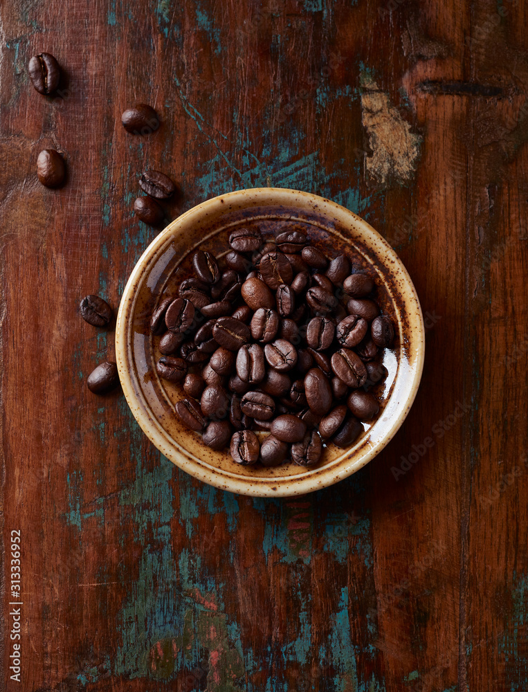 Fototapeta premium Coffee beans on rustic wooden background. Top view. 