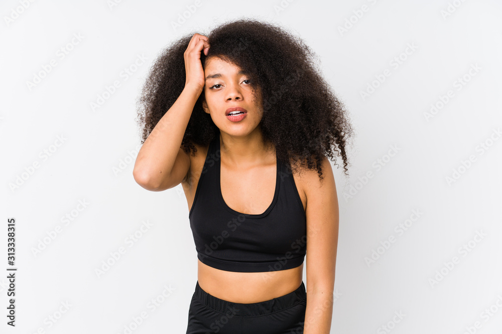 Young african american sporty woman tired and very sleepy keeping hand on head. Young african american sporty woman tired and very sleepy keeping hand on head.