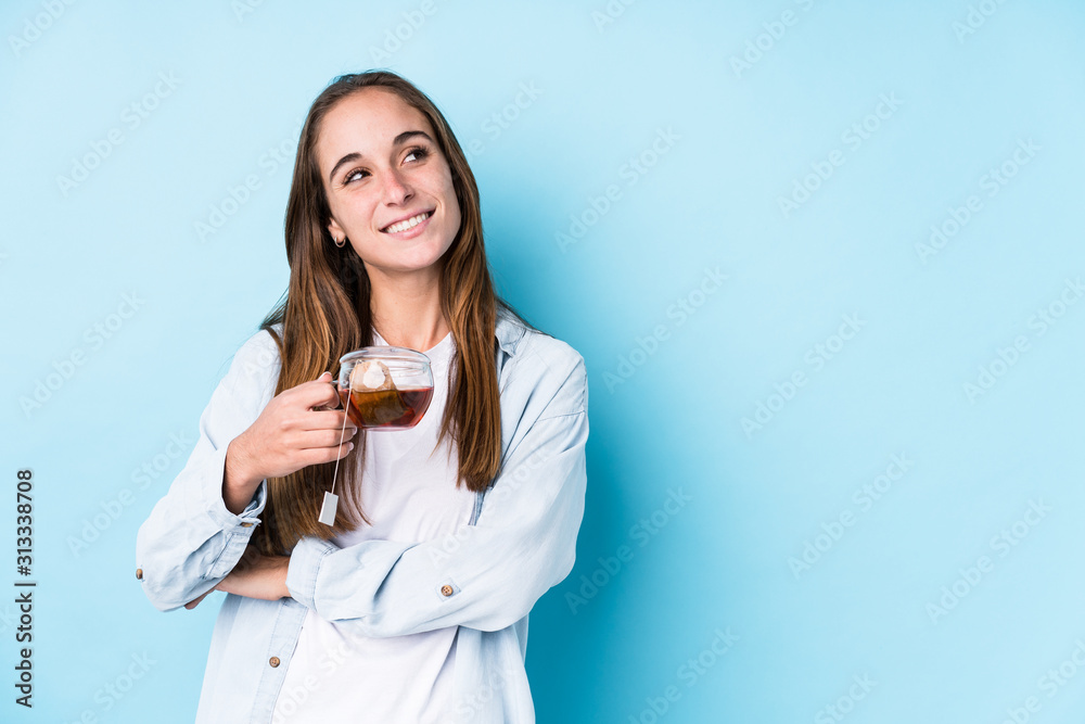 Young caucasian woman holding a tea isolated smiling confident with crossed arms. Young caucasian woman holding a tea isolated smiling confident with crossed arms.