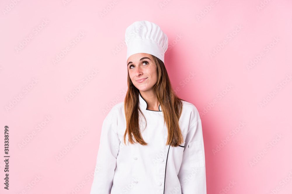 Young caucasian chef woman isolated dreaming of achieving goals and purposes