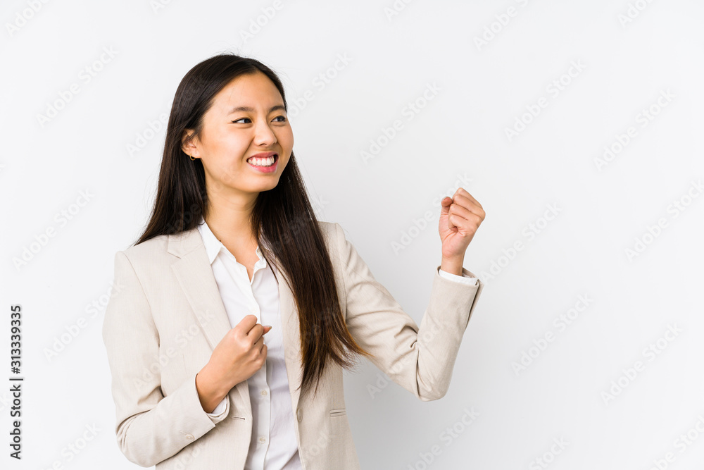 Young business chinese woman isolated raising fist after a victory, winner concept. Young business chinese woman isolated raising fist after a victory, winner concept.