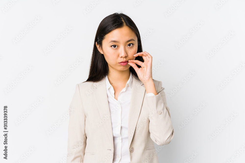Young chinese business woman isolated with fingers on lips keeping a secret. Young chinese business woman isolated with fingers on lips keeping a secret.