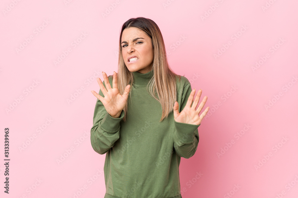 Young caucasian woman isolated rejecting someone showing a gesture of disgust.