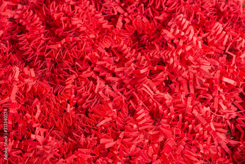 Red Paper Strips Filling From A Package Box