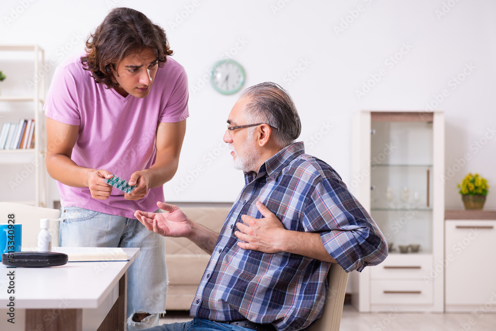 Young student and his old grandpa at home Young student and his old grandpa at home