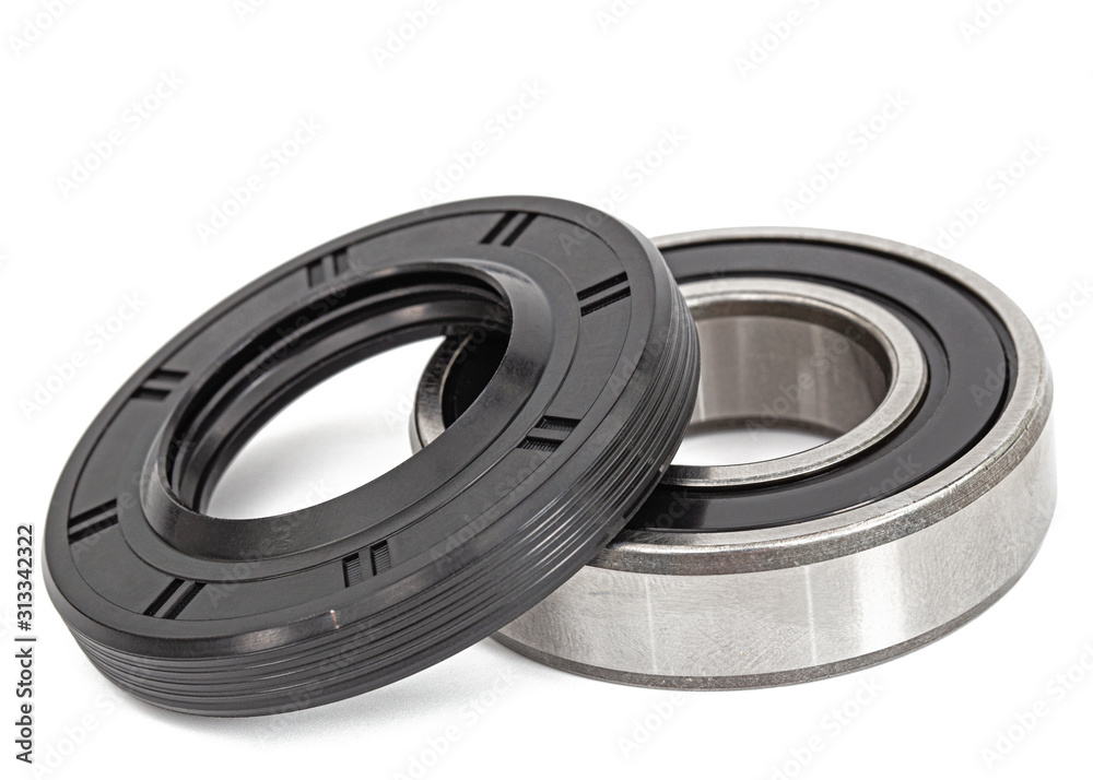 Ball bearing and oil seal for machine repair, isolated on white background Ball bearing and oil seal for machine repair, isolated on white background