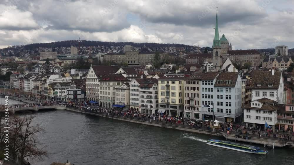 Zurich, Switzerland - April, 2019 - Parade of the Zunfte (guilds) along the Limmat River during Sechselauten (Spring Holiday). Zurich, Switzerland - April, 2019 - Parade of the Zunfte (guilds) along the Limmat River during Sechselauten (Spring Holiday).