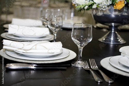 Table setting with glasses, plates, napkins and food