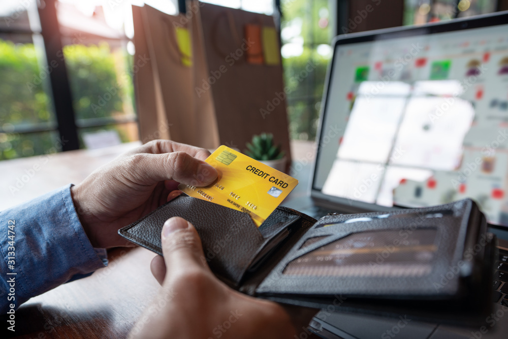 Online shopping credit card data security concept, Hands holding credit card and using smart phone or laptop to shopping or making online payment. Online shopping credit card data security concept, Hands holding credit card and using smart phone or laptop to shopping or making online payment.