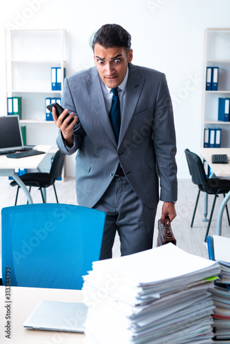 Businessman with heavy paperwork workload