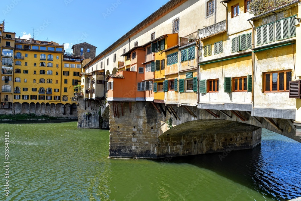 Bright sunny day with green river and architectural buildings surrounding