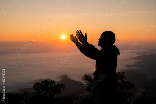 Fototapeta Silhouette of christian man hand praying,spirituality and religion,man praying to god