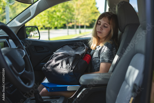 Sad/Depressed teen girl sitting in a car/suv while being driven to/picked up from school.